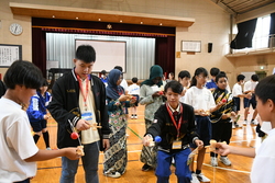 マレーシアの学生にけん玉の遊び方を教えている